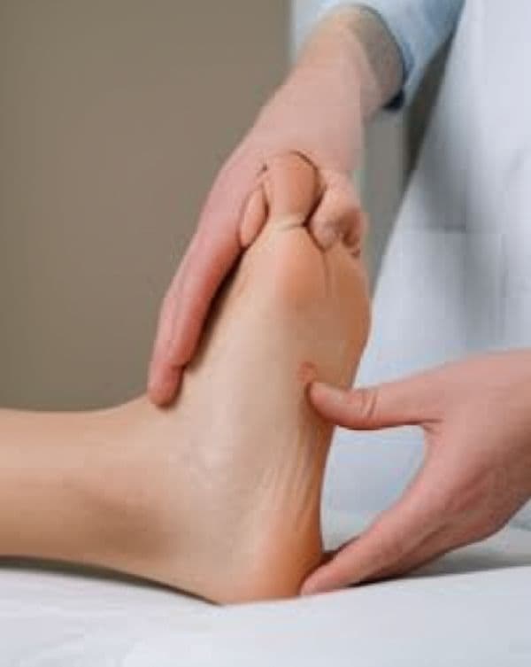 Podiatrist treating a patient's achilles tendon