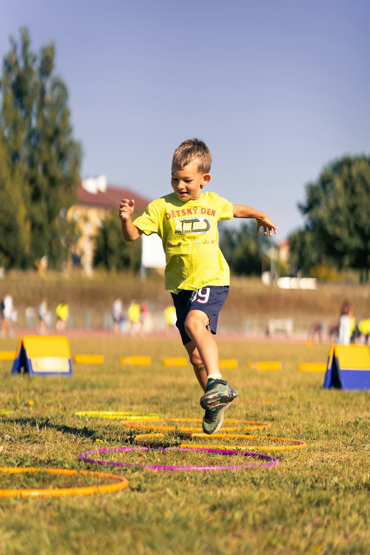 Young boy jumping through hoops during outdoor activity