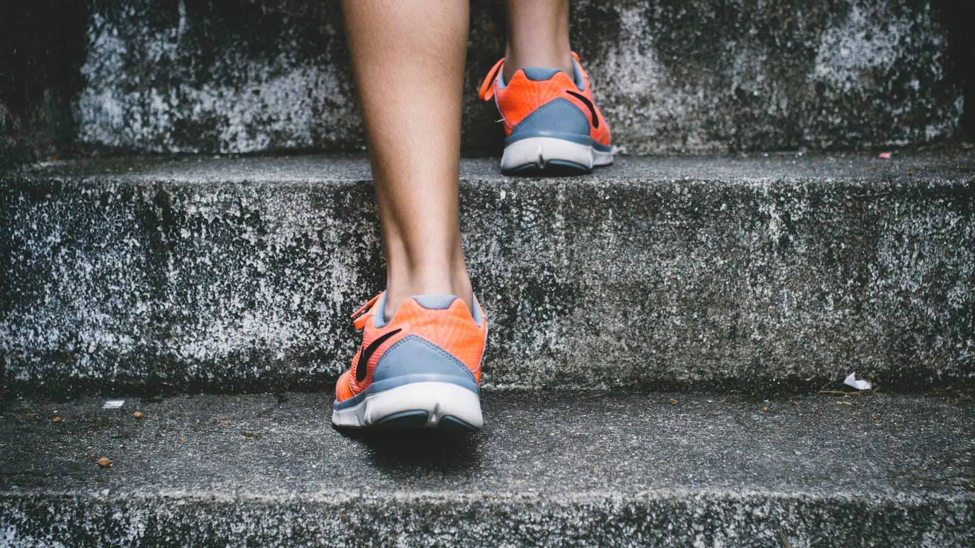 Close-up of runner's feet on stairs in running shoes