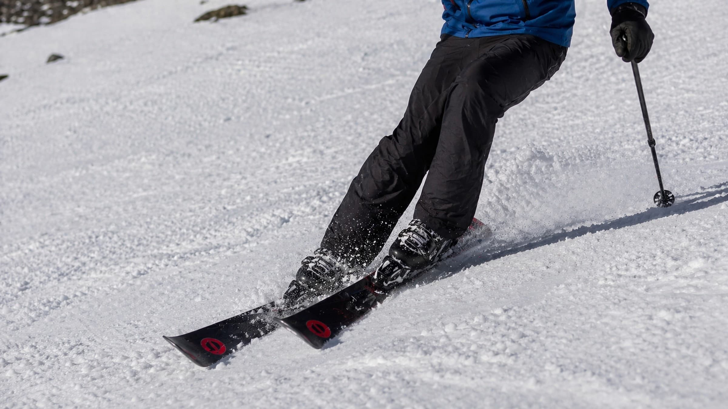 Skier carving down a snowy mountain slope