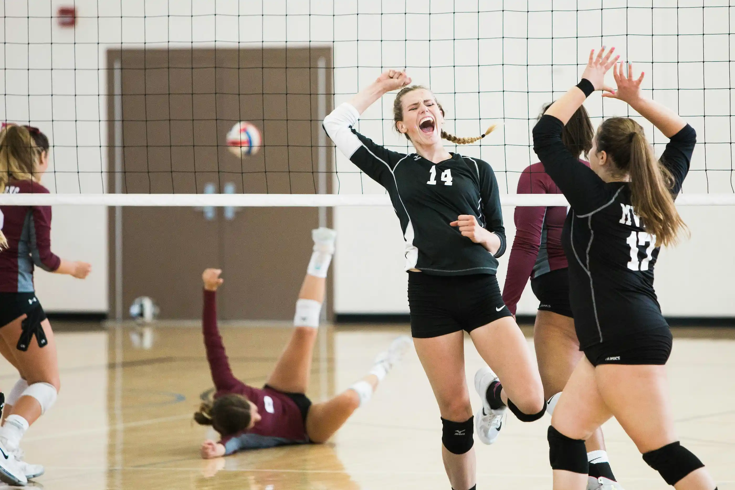 Volleyball players celebrating during a match