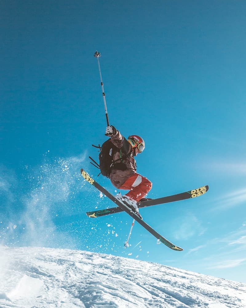Skier carving down a snowy mountain slope