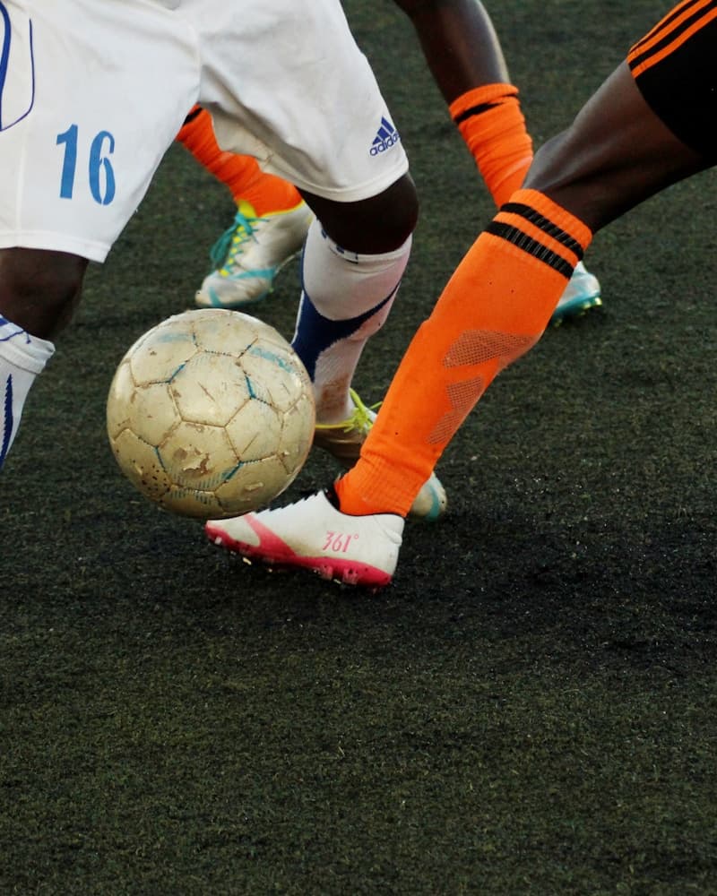 Soccer player dribbling the ball on the pitch