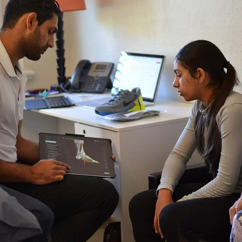 Podiatrist discussing foot symptoms with a patient