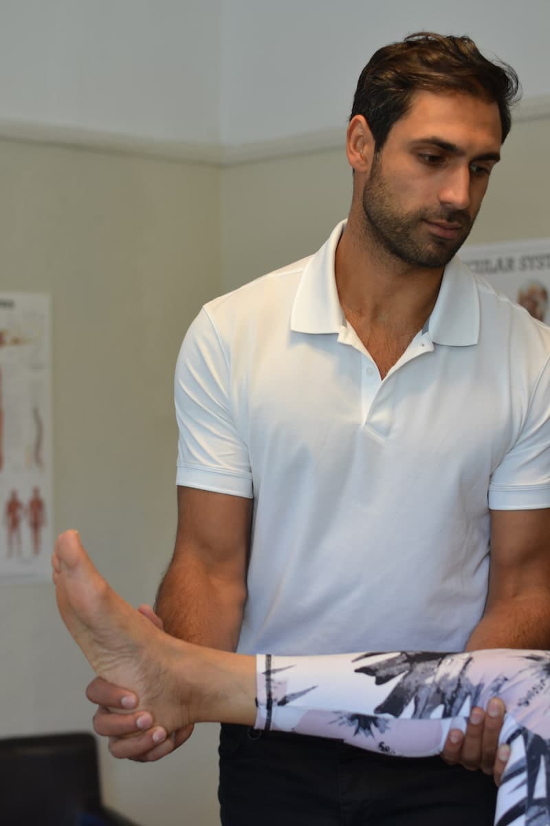 Steve Singh examining a patient's foot and ankle