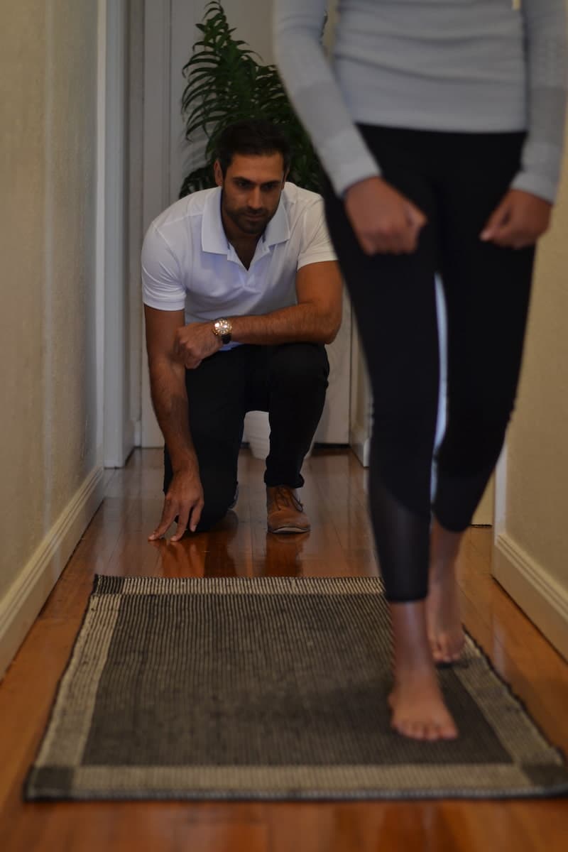 Podiatrist assessing a patient's gait and lower-limb movement
