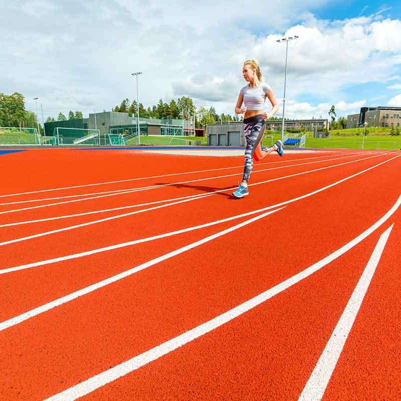 young-woman-running-on-sports-tracks-PNBNHWP